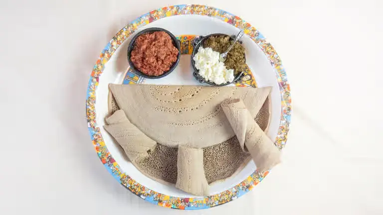 Kitfo – Ethiopian seasoned minced beef with kibbeh and mitmita spice at Merkato Restaurant Winnipeg